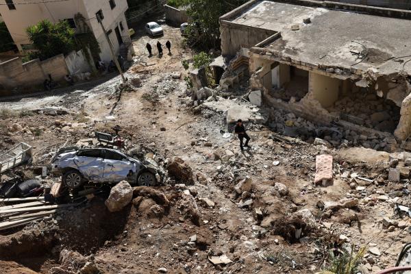 People check the destruction in the aftermath of an Israeli military raid in Qabatiyah south of Jenin in the occupied West Bank, on September 20, 2024. Qabatiyah is located in the north of the West Bank, where the military has been carrying out large-scale raids since late August that the Palestinian health ministry says have left dozens dead. 