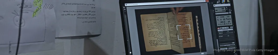 A researcher digitizes scans of a historical manuscript in Gaza.