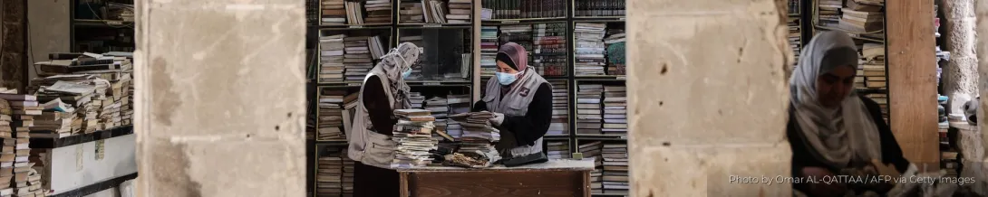 A team works to rescue and restore texts in the library of the Great Omari Mosque after attacks during Israel's genocide in Gaza.