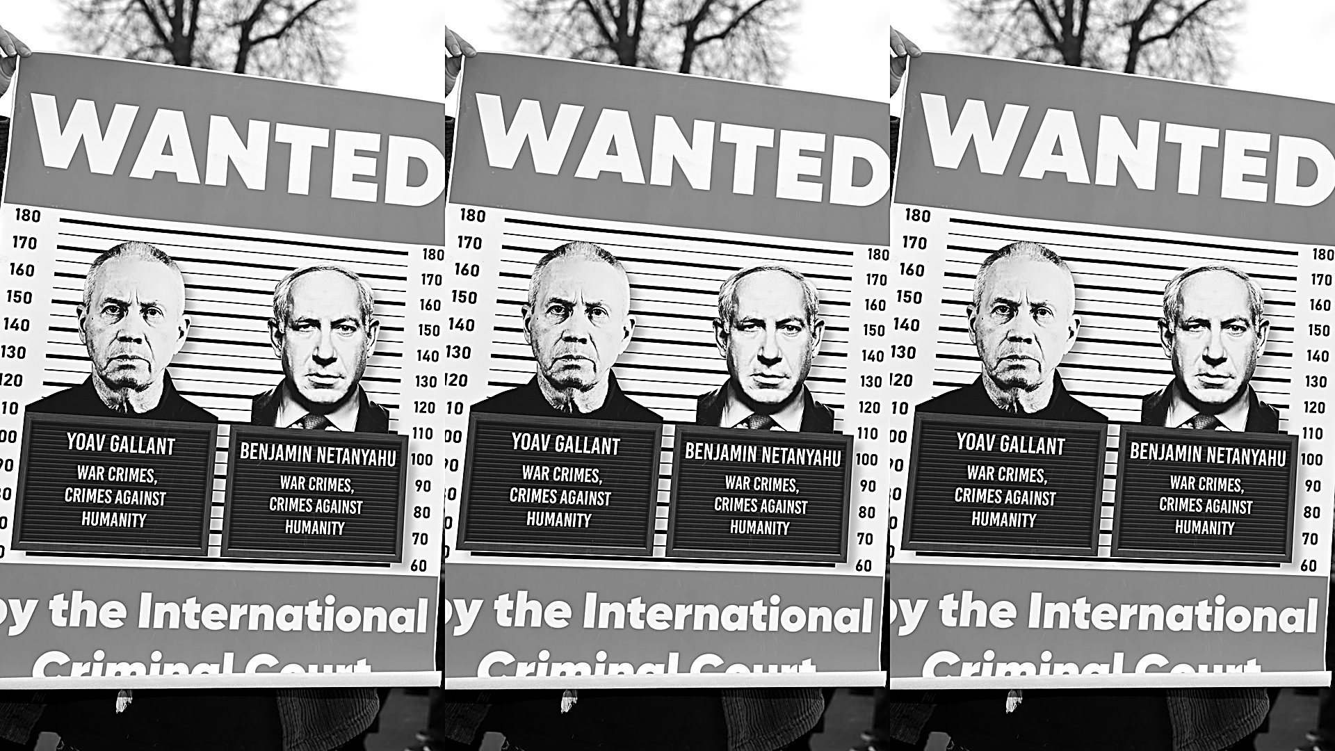 Protest sign has mock-mugshot photos of Israeli Defense Minister Yoav Gallant and Prime Minister Benjamin Netanyahu that say "WAR CRIMES, CRIMES AGAINST HUMANITY." Surrounding the mugshot graphic is large text that reads "WANTED BY THE INTERNATIONAL CRIMINAL COURT."