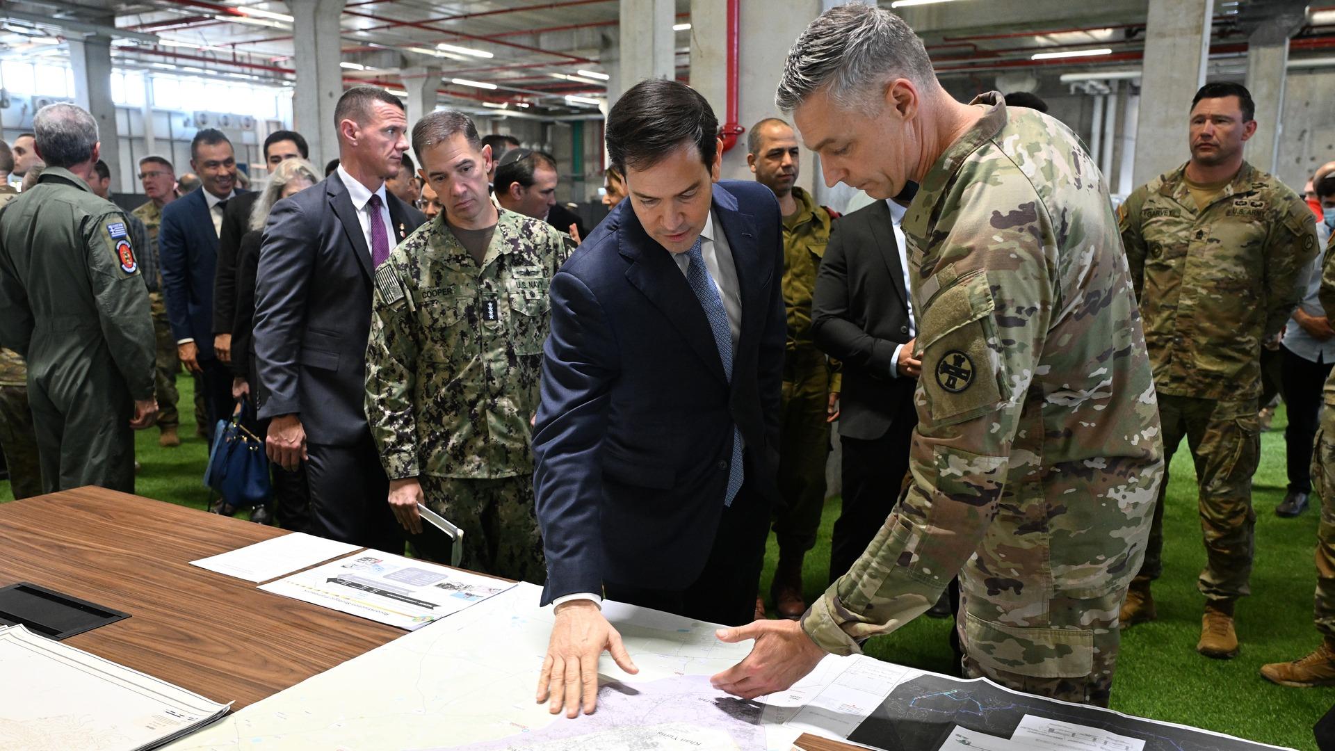Secretary of State Marco Rubio meets with CENTCOM officials at the CMCC in Kiryat Gat, Israel. They look at a large map of Gaza as CMCC personnel brief Sec. Rubio.