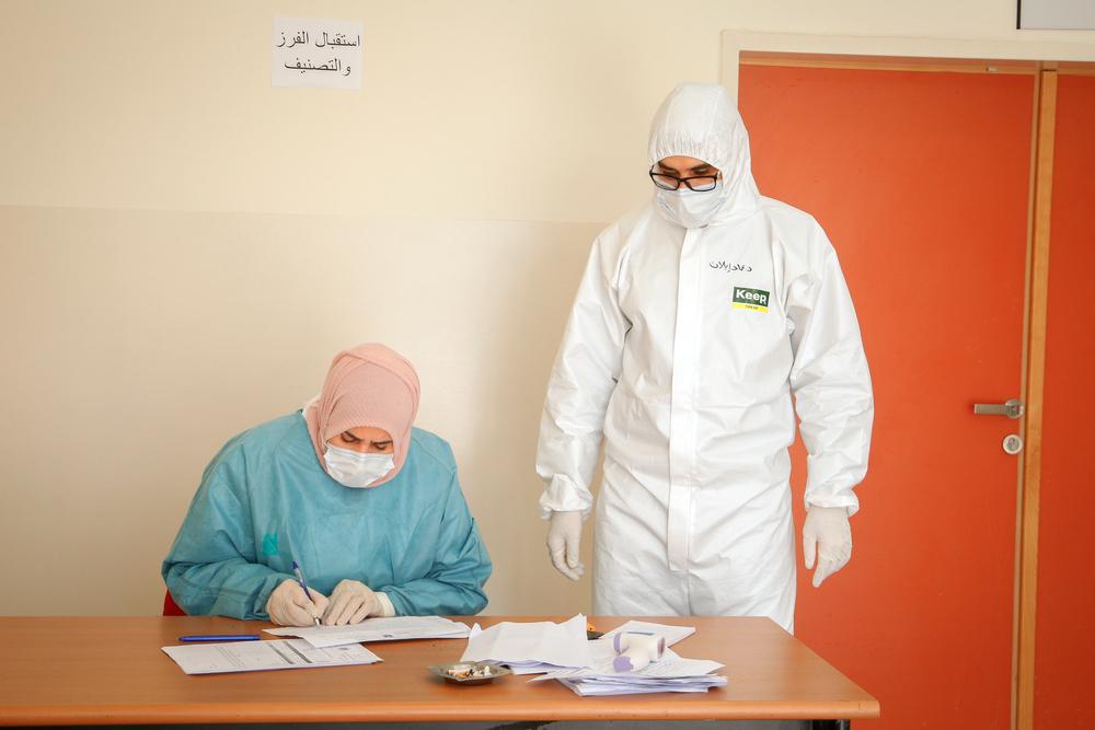 Doctors in personal protective equipment (PPE), including suits, masks, and gloves, prepare to receieve patients in a COVID-19 quarantine center in Qalqilya, a West Bank town on April 19, 2020.
