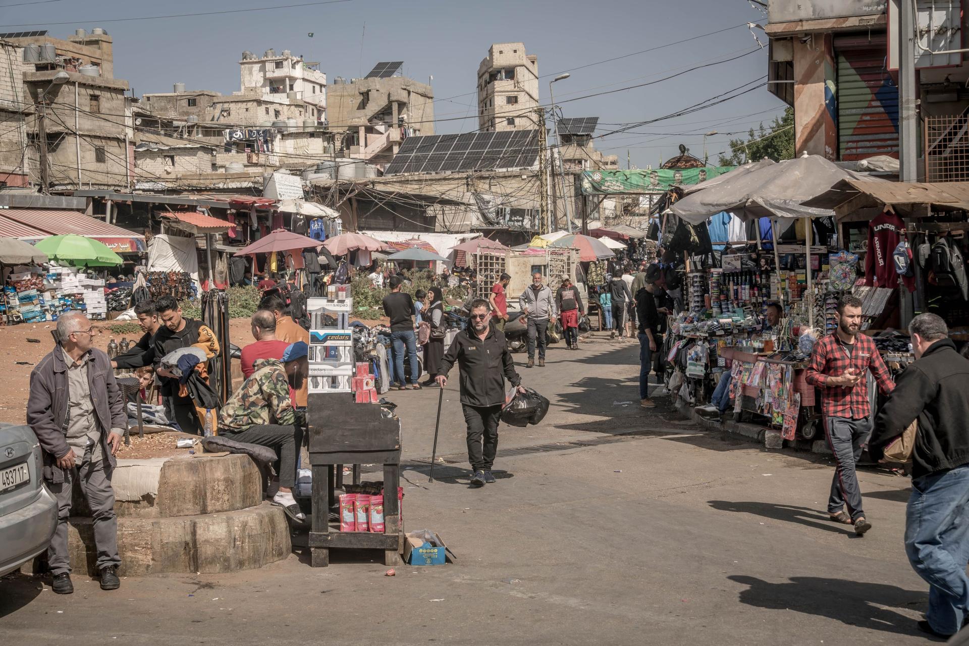 Palestinians walking in a market of the crowded Shatila refugee camp in Beirut, March 2023.