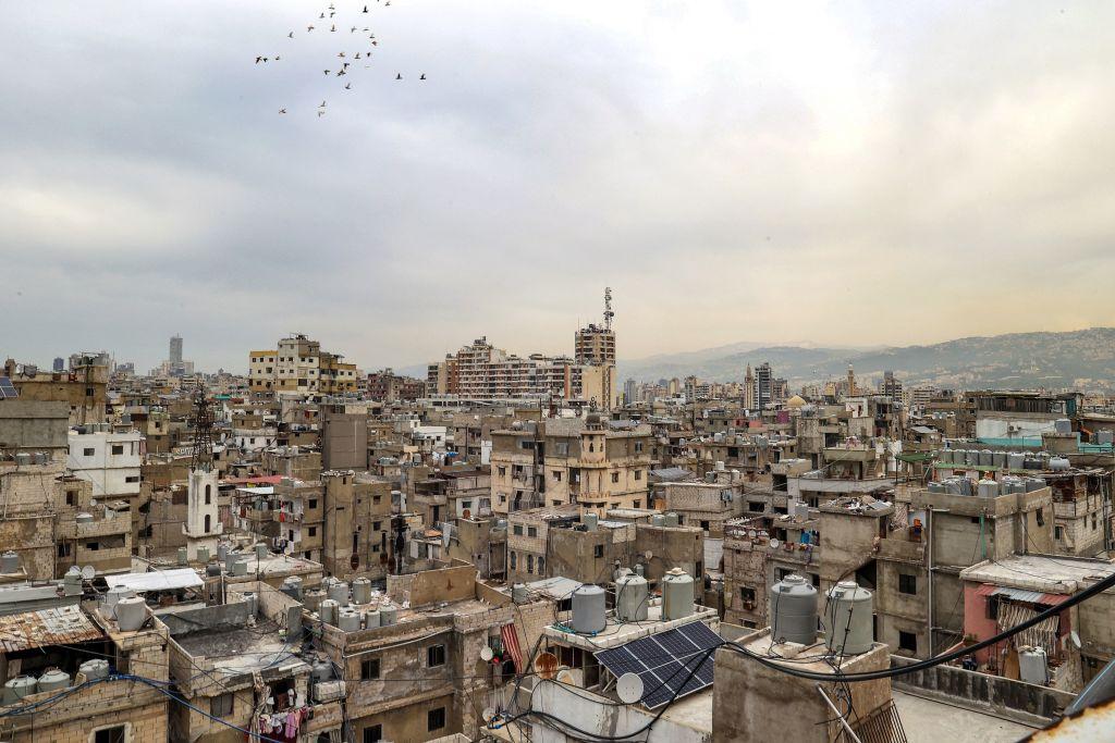 Birds fly over the rooftops of homes in the crowded Shatila Refugee Camp in Beirut, Lebanon.
