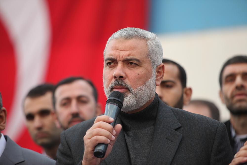 Head of the Hamas Political Bureau, Ismail Haniyeh, addresses a gathering in Turkey, with a Turkish flag in the backdrop, during a visit and commemorative event at the Mavi Marmara ship. 