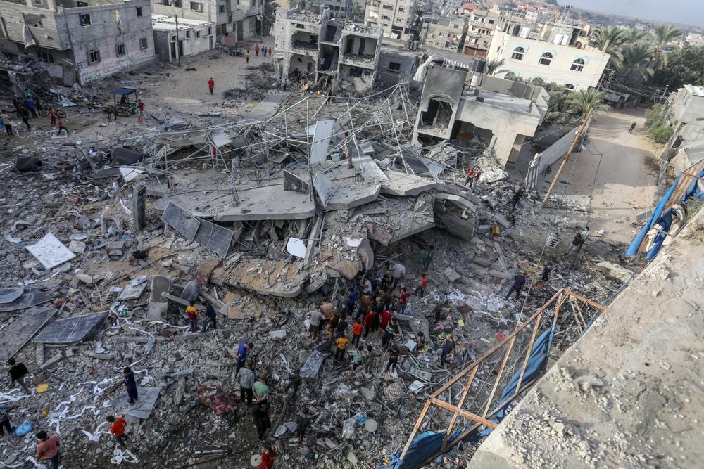Aerial view of Palestinians inspecting the damage to their home after an Israeli airstrike on Rafah. November 11, 2023.
