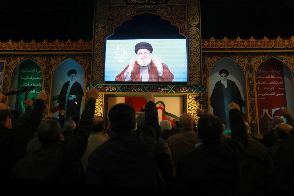 A large crowd attending a celebration of the 40th anniversary of the Iranian Revolution in the southern suburbs of Beirut listens to a speech by Hezbollah Secretary General Hassan Nasrallah via a large screen. Next to the screen displaying Nasrallah's speech are images of Ayatollah Khomeini and Ayatollah Khamenei. February 6, 2019.