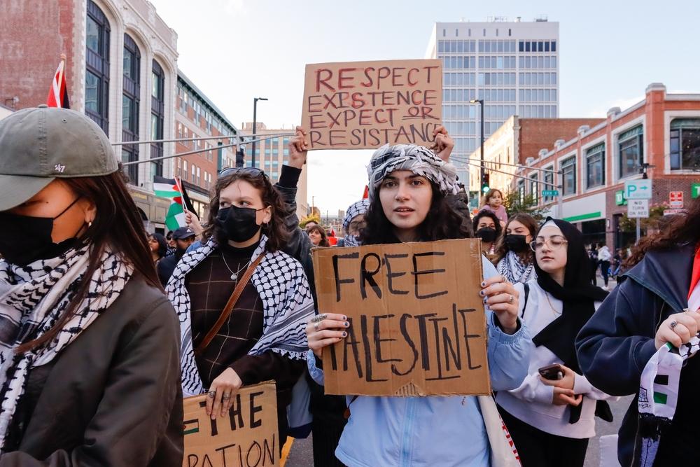 Protest in Cambridge, Massachusetts. Signs say "Free Palestine" and "Respect Existence or Expect Resistance."