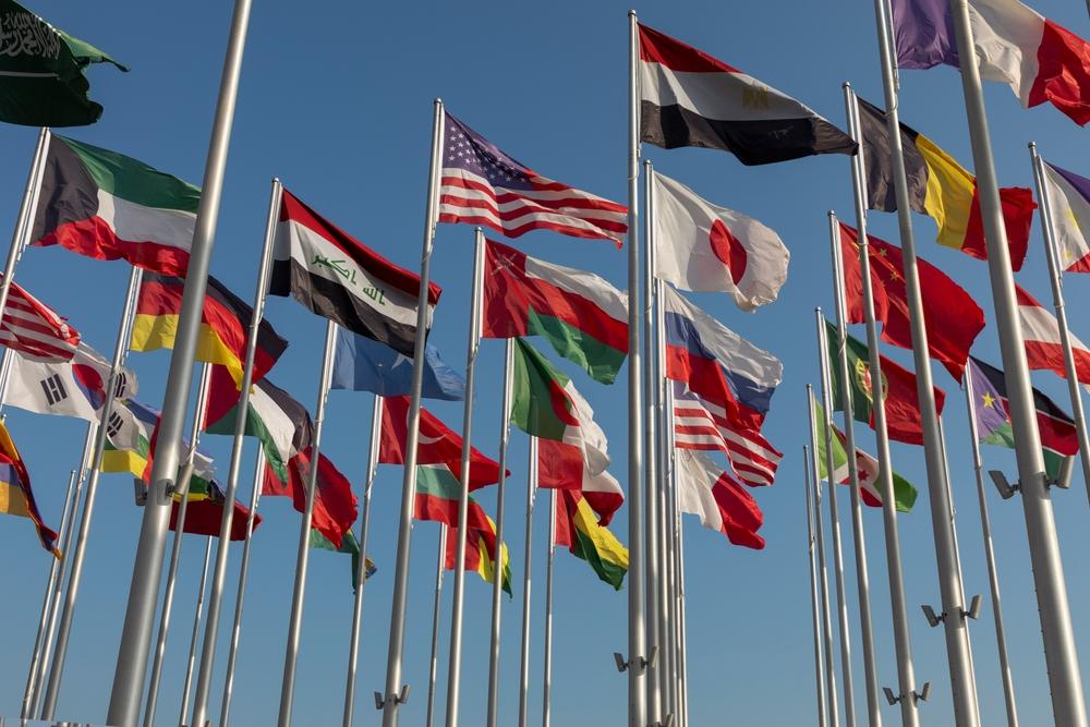 World flags, including Iraq, the United States, Egypt, Somalia, China, Japan, Oman, and others at the old port of Doha, Qatar.