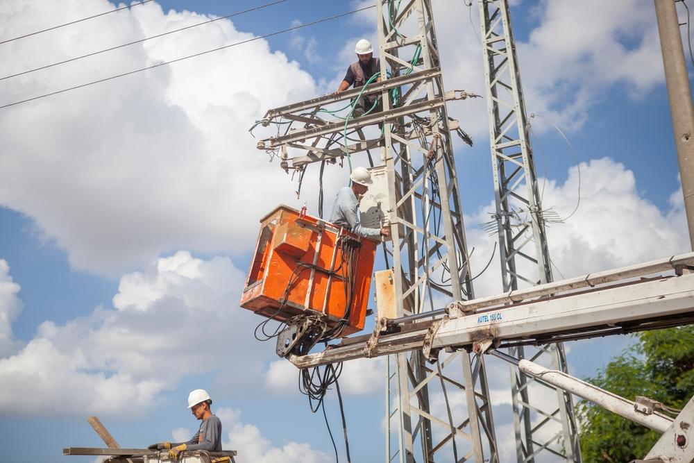 Engineers repair a damaged lamppost in the Gaza Strip after Israel's 2014 war on the besieged territory.