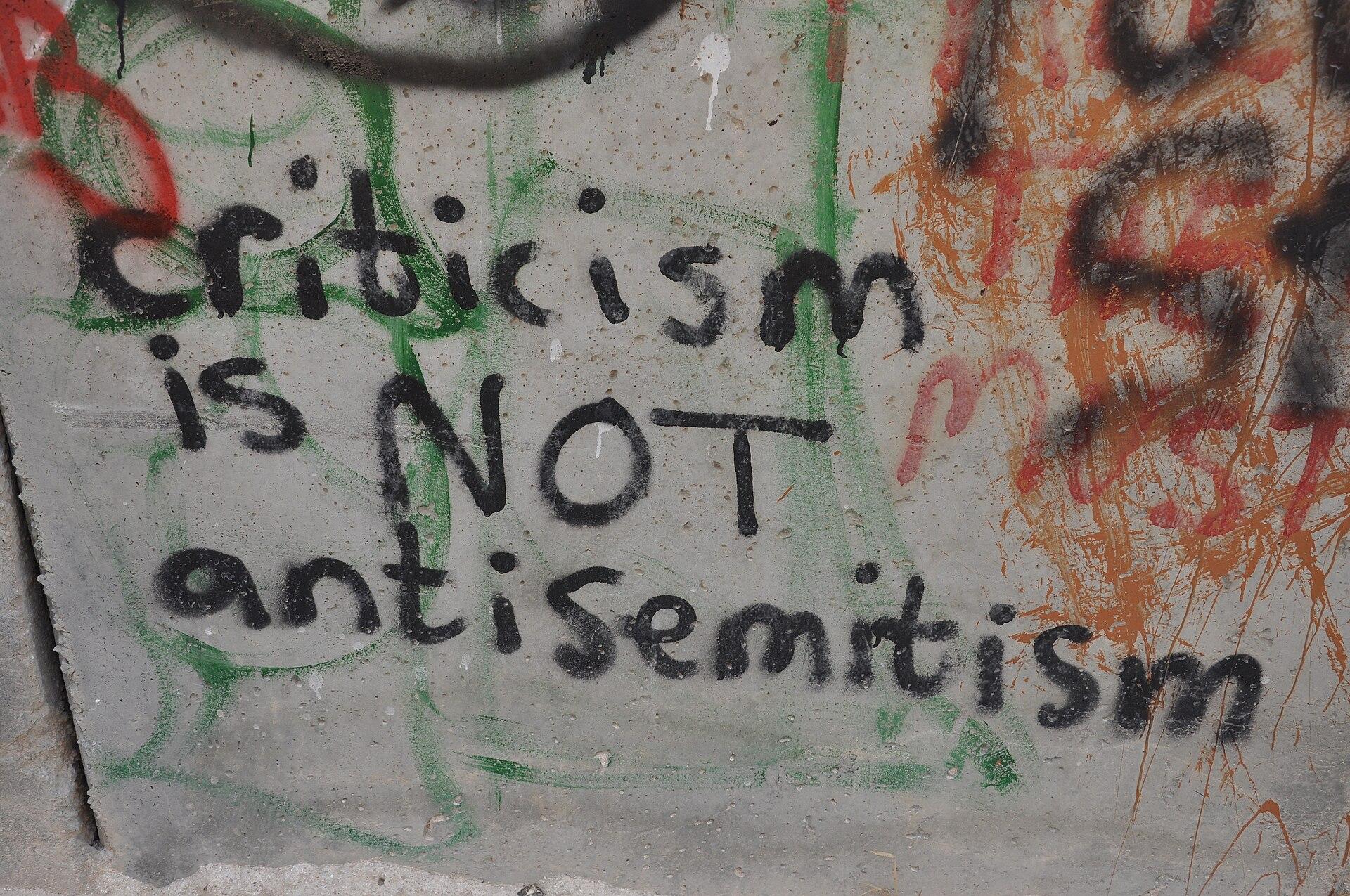 Graffiti on Israel's apartheid wall which says "criticism is NOT antisemitism."