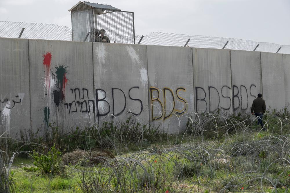 Grafitti on Israel's apartheid wall that says "BDS" several times in a row.