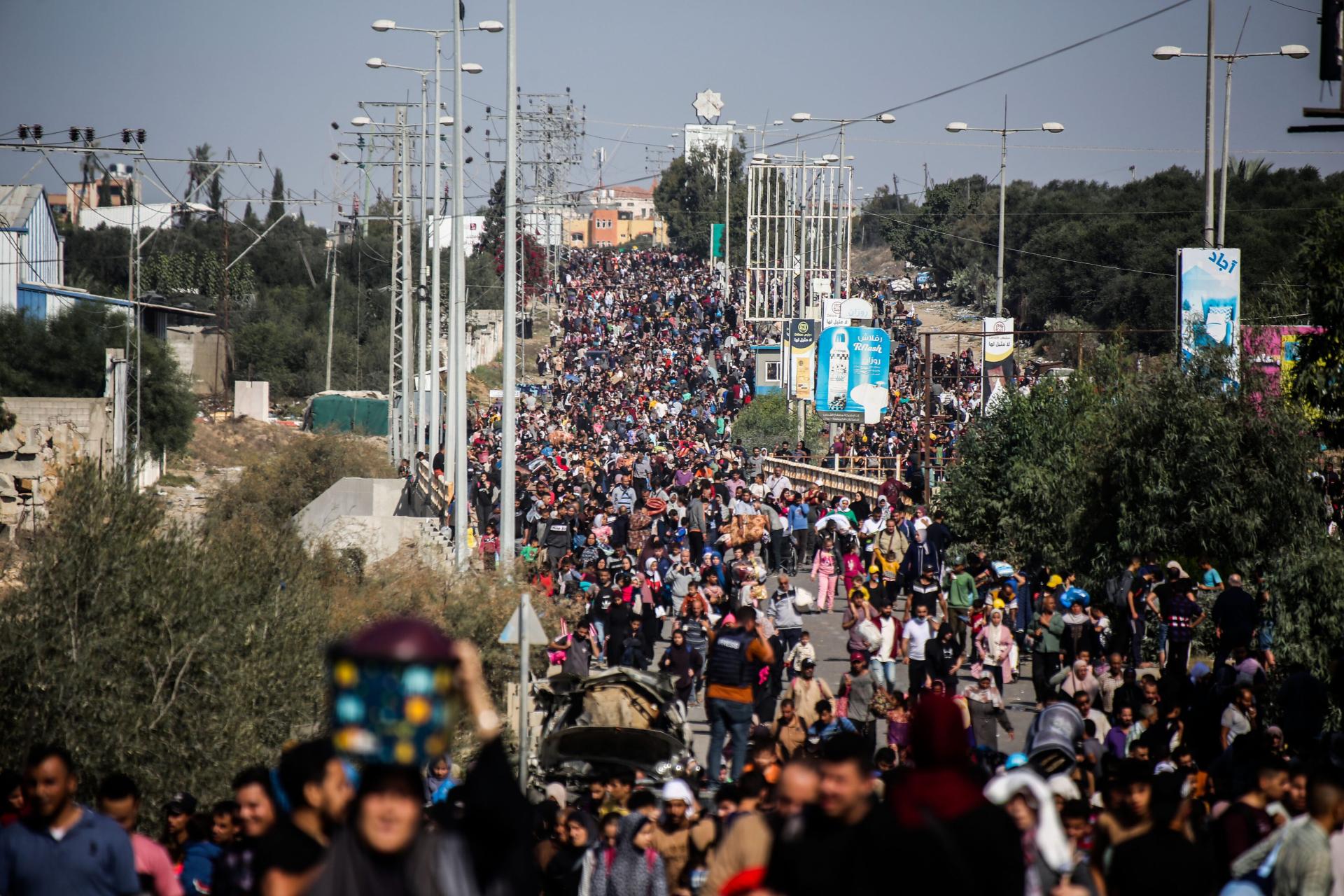 A massive crowd of Palestinians displaced from Gaza City walk along Salah al-Din Street with their belongings as they flee to the southern half of the Gaza Strip.