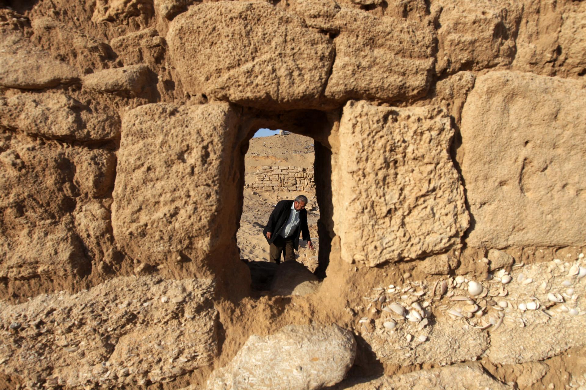 A Palestinian worker is seen through the Anthedon Harbor, or al-Blakhiyah, as he inspects the ancient archaeological site.