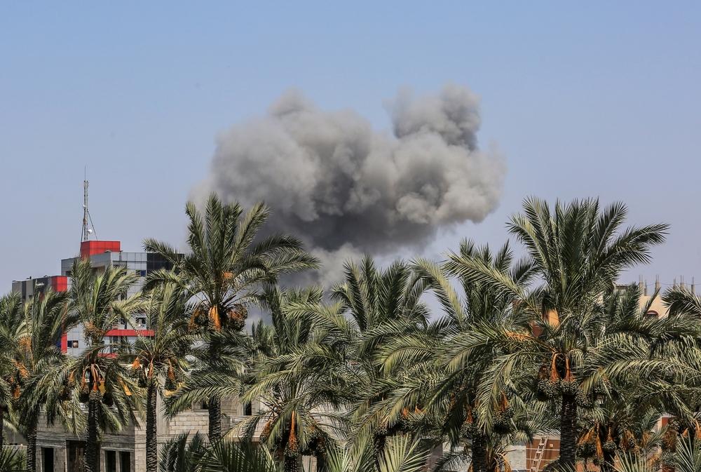 Smoke rises over date palm trees in Deir al-Balah, in the central Gaza Strip, a town known for its date trees and agricultural sites.
