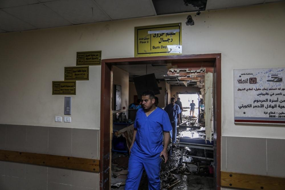 Doctors walk through the heavily-damaged burn unit of the Nasser Hospital in Khan Yunis.