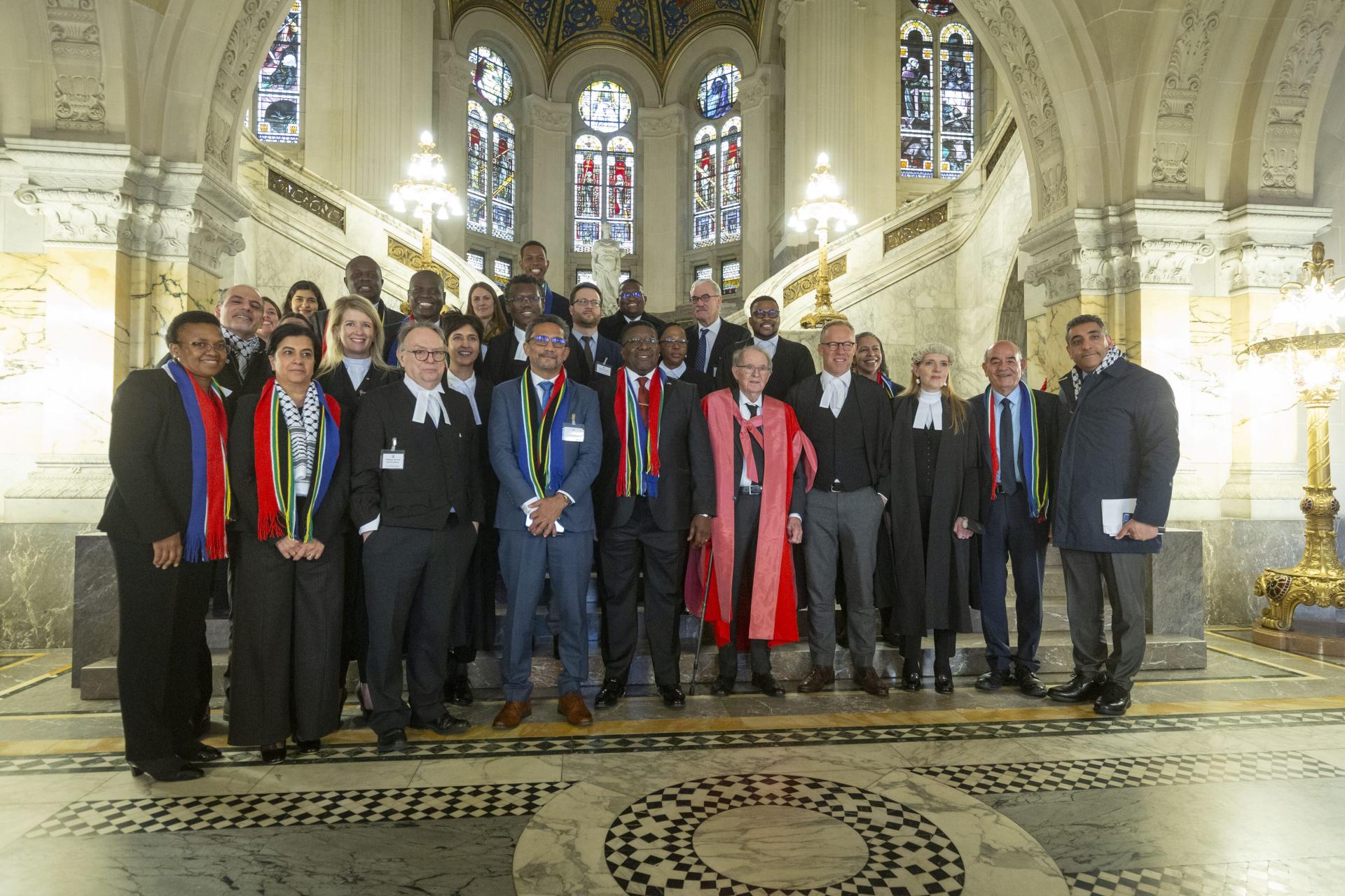 Members of the South African delegation pose for a photo at the International Court of Justice in The Hague, Netherlands after presenting its case against Israel for the crime of genocide in Gaza.