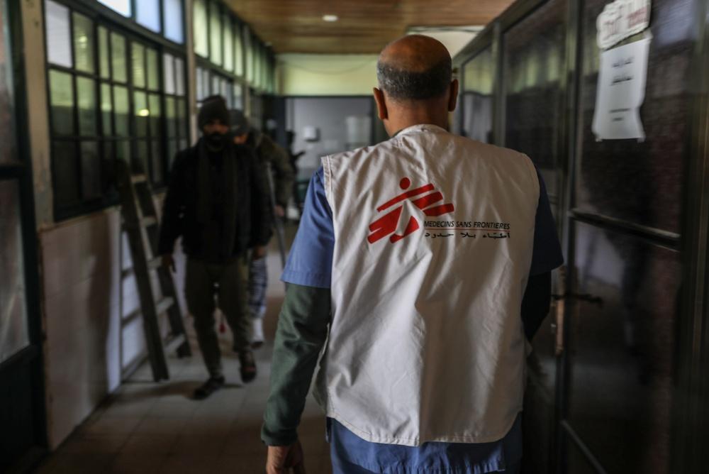 A doctor wearing a Doctors Without Borders (MSF) vest walks through the halls of the Nasser Medical Complex in Khan Yunis.