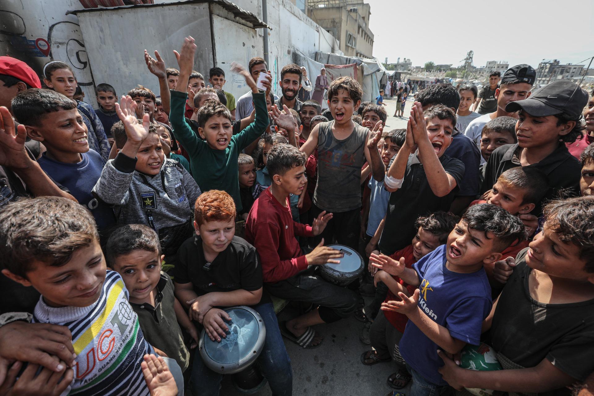 Children in Gaza City celebrate the announcement of a ceasefire agreement in October 2025.