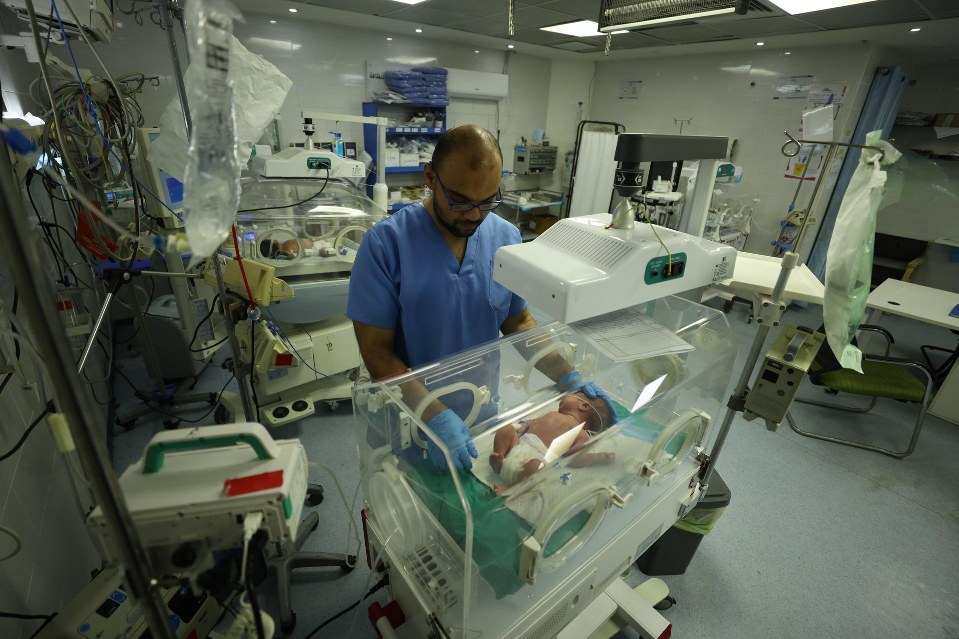 A doctor treats premature babies in the NICU of Gaza City's Al-Hulwa Hospital despite severe fuel and medical supply shortages that threaten the lives of the infants.