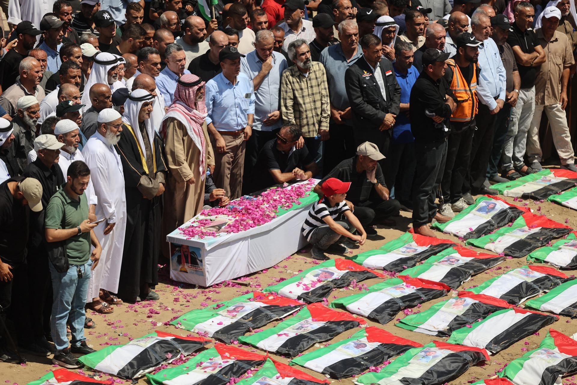 Aerial view of a mass funeral prayer for the Abu Sharia and al-Hasayna families who were massacred in Israeli airstrikes on their residential buildings in Gaza City's Al-Sabra neighborhood on August 4, 2026. While they were killed by Israel in November 2023, their remains were not recovered until August 2026.