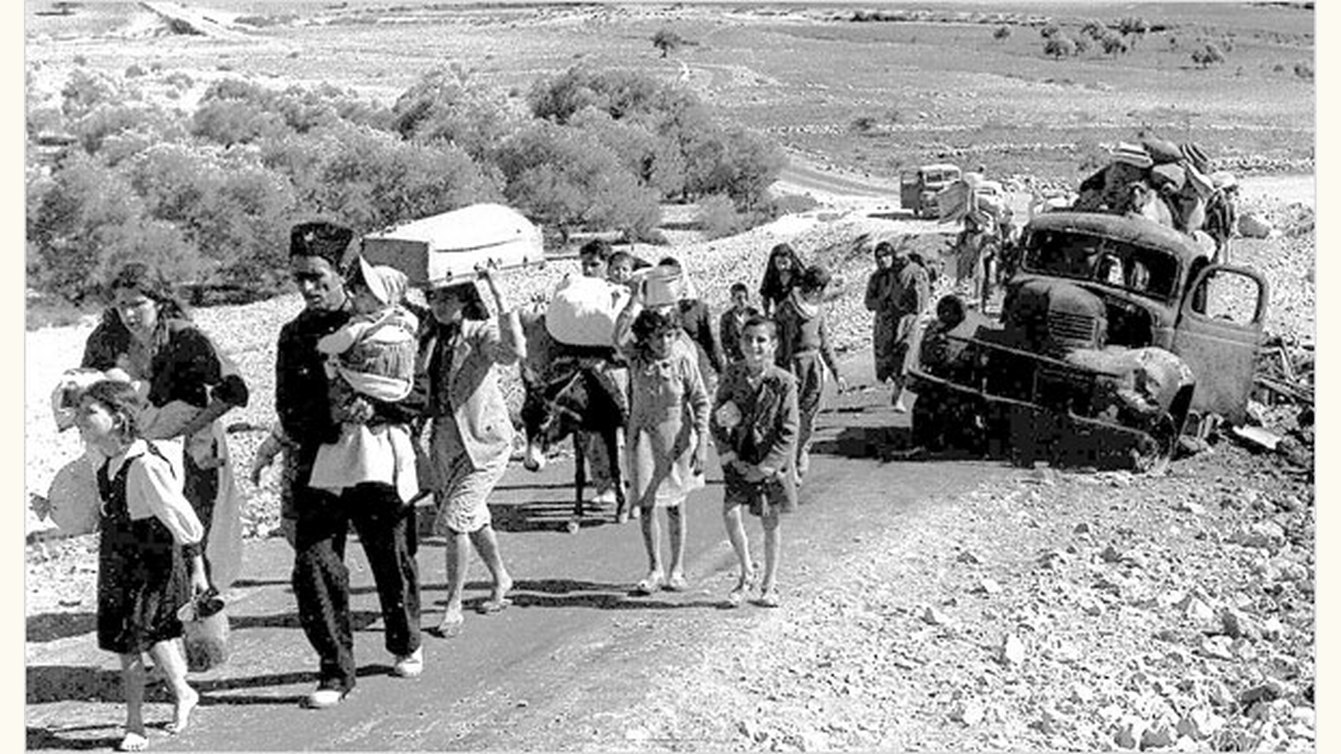 Palestinians forcibly expelled from their homes in the Galilee are forced to walk by foot as they carry their belongings. Dated October-November 1948.