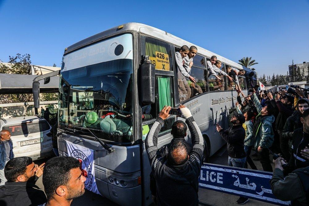 Palestinian prisoners released in an exchange deal with Israel arrive in a bus, where they greet a large crowd welcoming them home to Gaza. February 2025.