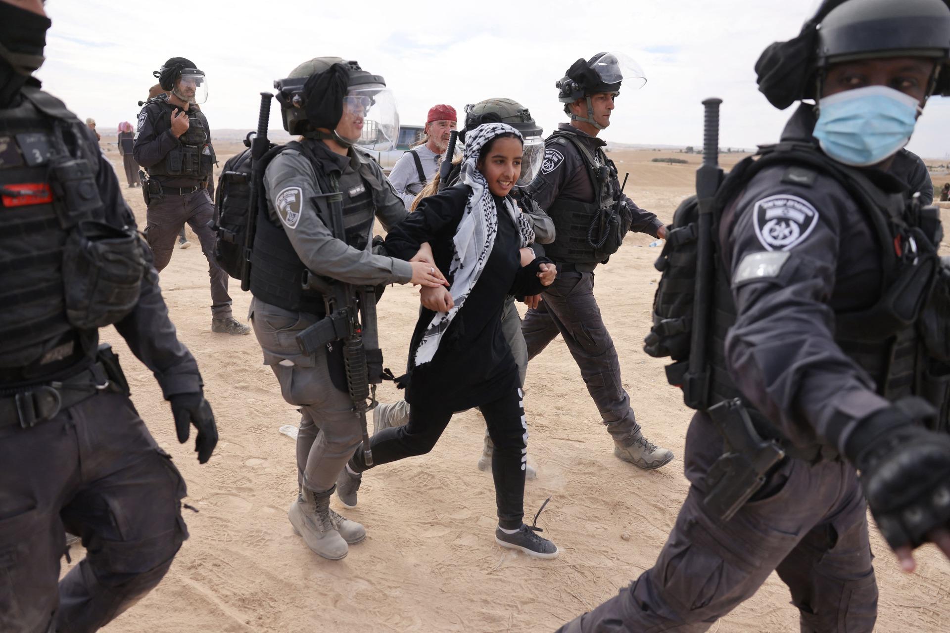Israeli police arrest a young Palestinian Bedouin woman as she protests the JNF's afforestation project in Sawe al-Atrash, one of several areas of the Negev impacted by this JNF project.