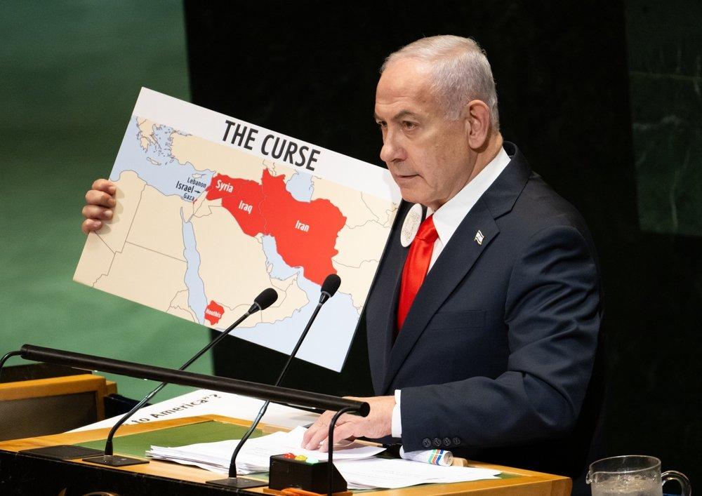 Israeli Prime Minister Benjamin Netanyahu addresses the UN General Assembly, carrying a map which highlights Iran, Iraq, Syria, Lebanon, and Gaza, labeling them "the curse." September 2025.