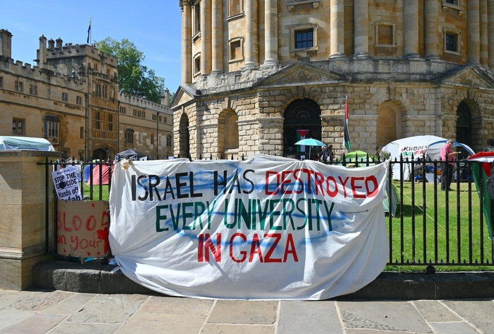 Banner reads "ISRAEL HAS DESTROYED EVERY UNIVERSITY IN GAZA."