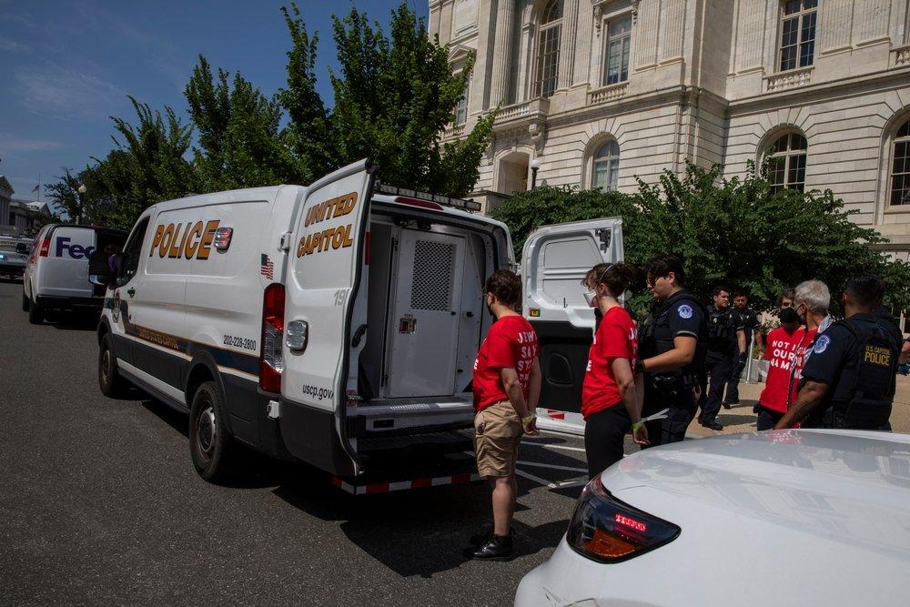 Capitol police arrest Jewish activists in a protest against Israel's genocidal war on Gaza. They wear t-shirts that read "NOT IN OUR NAME."