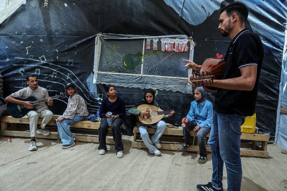 In a music class for displaced Palestinians in the Gaza Strip, girls learn to play the oud and guitar.