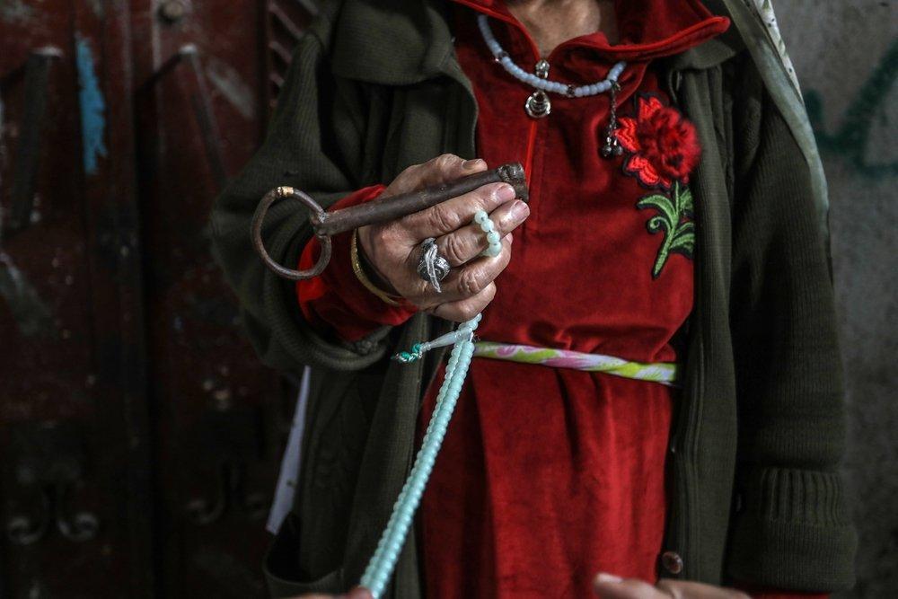 A Palestinian woman carries the key to the home she was forcibly expelled from in 1948. May 15, 2022.
