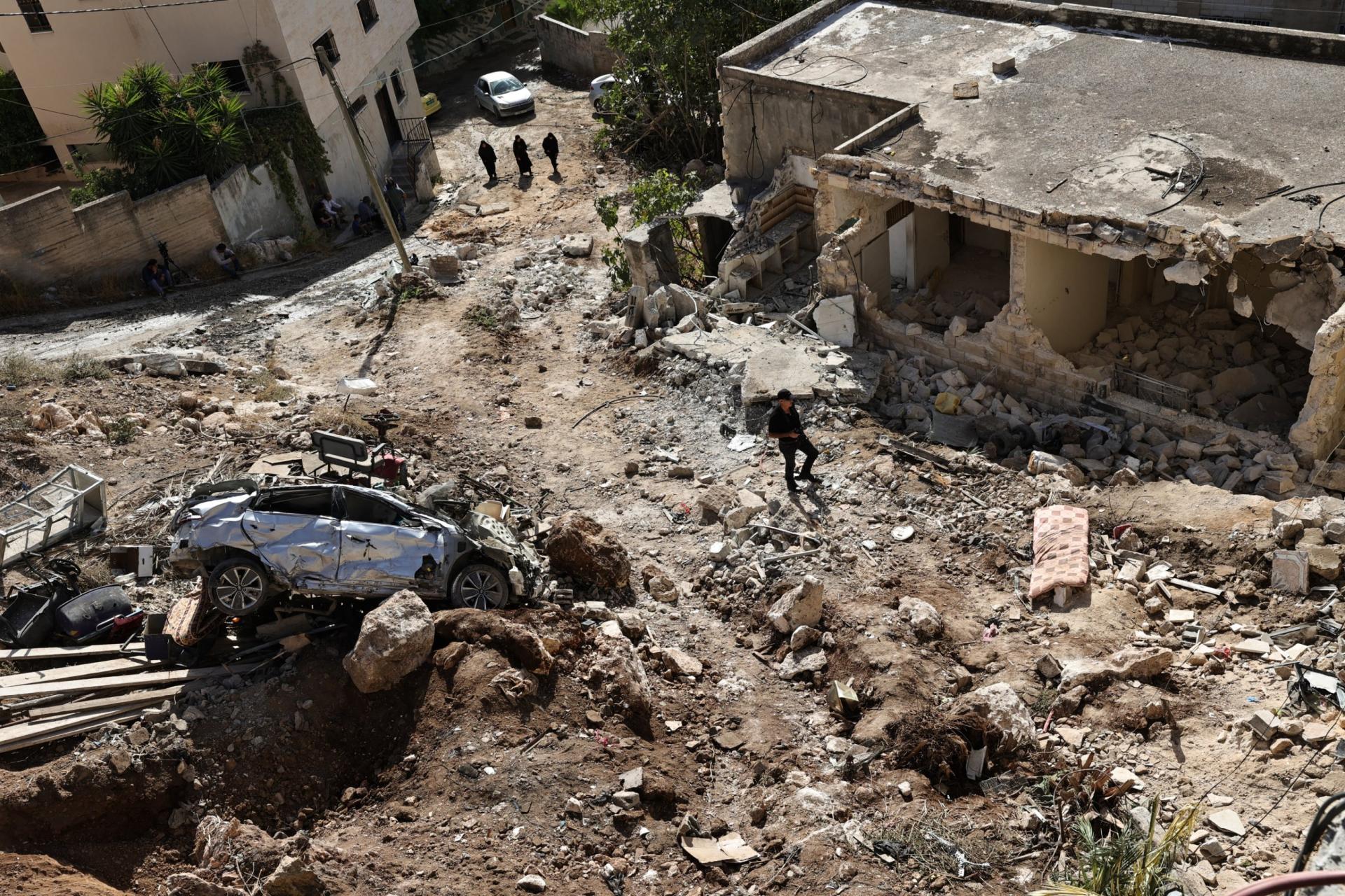 People check the destruction in the aftermath of an Israeli military raid in Qabatiyah south of Jenin in the occupied West Bank, on September 20, 2024. Qabatiyah is located in the north of the West Bank, where the military has been carrying out large-scale raids since late August that the Palestinian health ministry says have left dozens dead. 