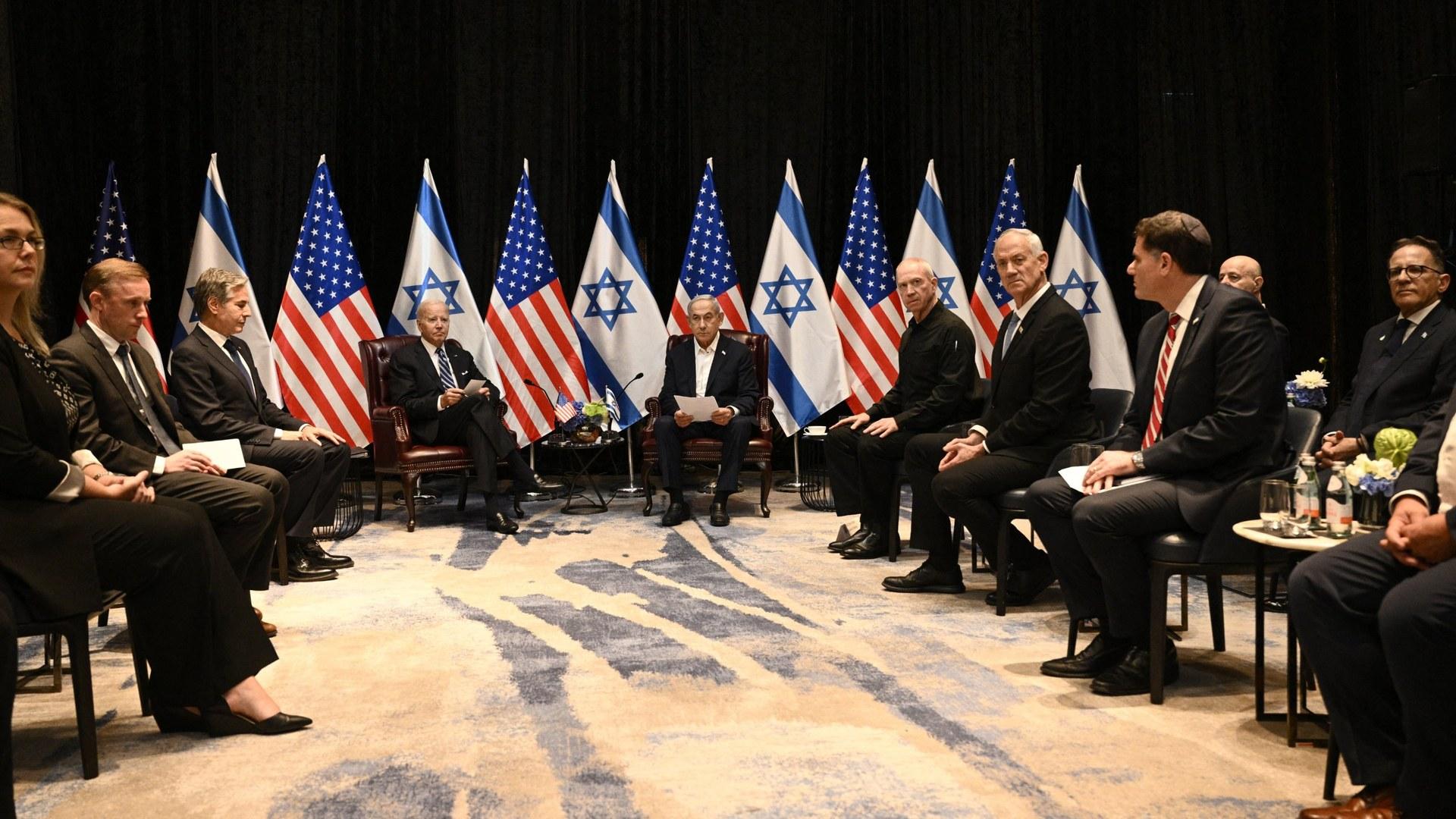 National Security Advisor Jake Sullivan (2nd L), US Secretary of State Antony Blinken (3rd L) and US President Joe Biden (4th L) listen to Israel's Prime Minister Benjamin Netanyahu (top R-C) as they join a meeting of the Israeli war cabinet in Tel Aviv on October 18, 2023