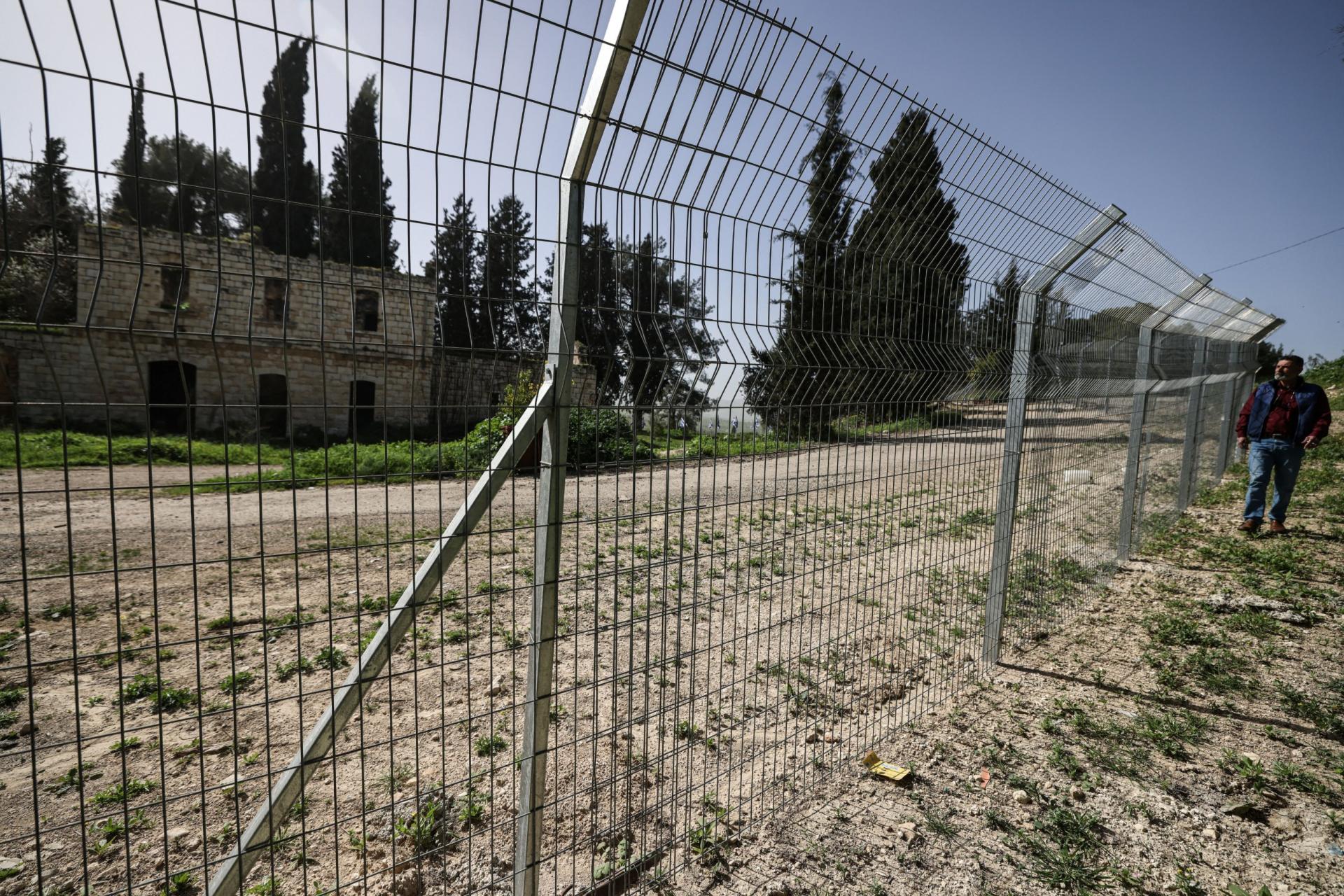 Palestinian Ameed Dusouki, a member of the Burqa village council, walks along a fence installed by Jewish settlers after they announced their control over the historical Al-Masoudiya Ottoman era train station, which operated between the Palestinian cities of Nablus and Tulkarm in the 1920s, just north of the city of Nablus, in the northern Israeli-occupied West Bank on February 15, 2026