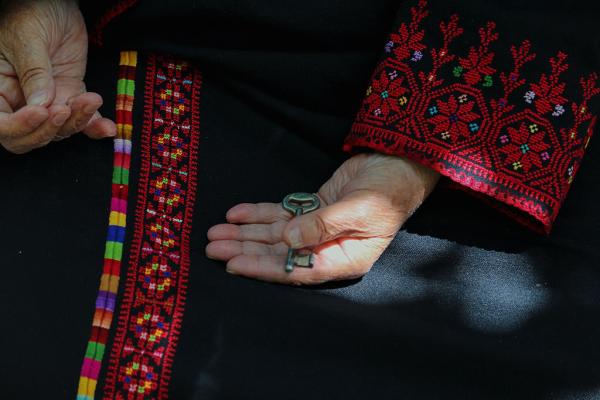 A Palestinian refugee holds the key to her family's home of which her family was dispossessed during the 1948 Nakba.