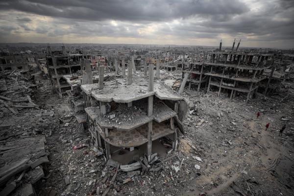 Aerial view of Israel's destruction of Gaza City's Sabra neighborhood after the October 2025 ceasefire deal was signed. Features a destroyed multi-level building, surrounded by rubble of other destroyed buildings.