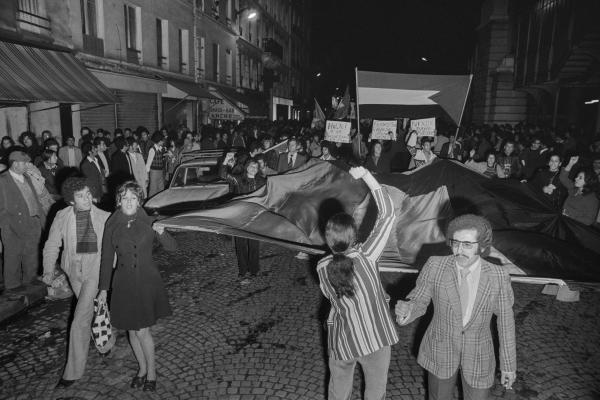 Protest in support of Palestinians, Egypt, and Syria during the 1973 War in Paris. Protestors carry Palestinian flags. One sign reads "Nixon, Dayan: Assassins."