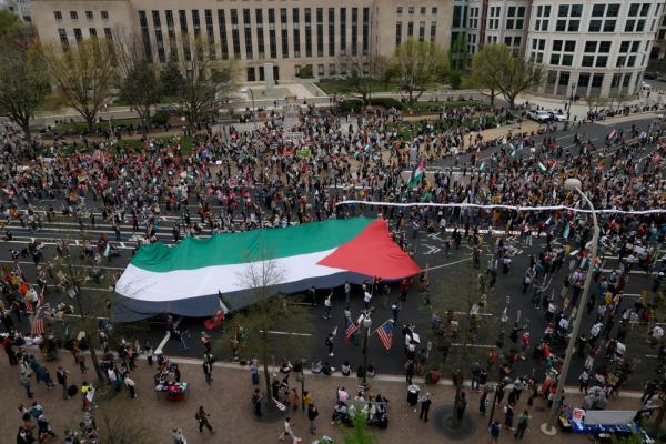 Palestine rally in the United States, protestors carry an extra-large Palestinian flag.