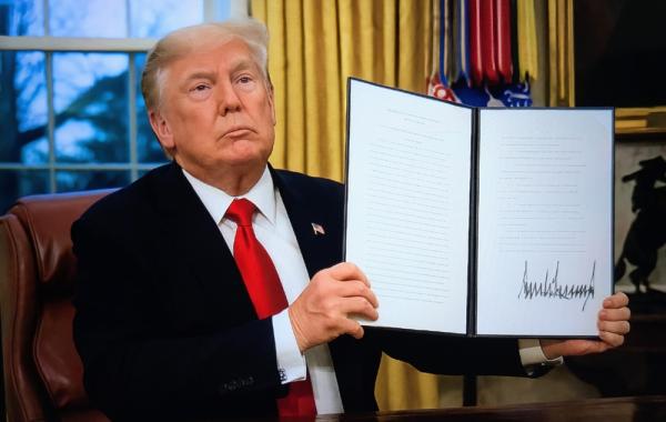 President Trump shows a signed executive order from the Oval Office of the White House on inauguration day. January 20, 2025.