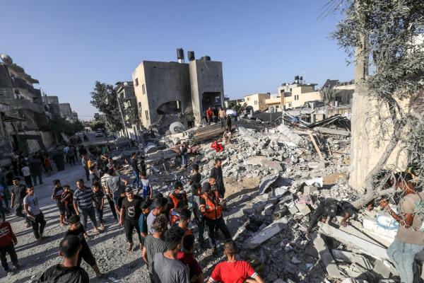 Palestinian first responders and civilians look for survivors following an Israeli airstrike on the Rafah refugee camp in Gaza.