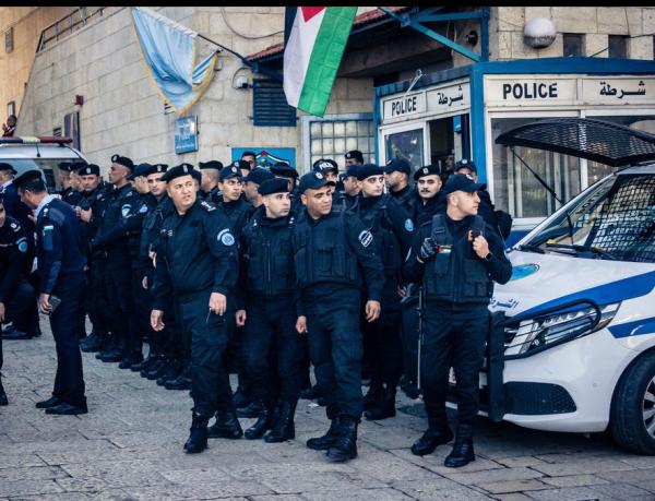 A large crowd of Palestinian Authority (PA) security forces stand outside of a police station in Bethlehem in the West Bank.