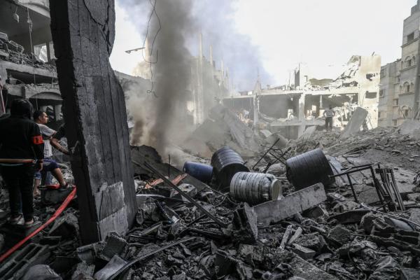Palestinian Civil Defense team searches for survivors amid the rubble of a destroyed home following a heavy Israeli air raid over Rafah on October 17, 2023.