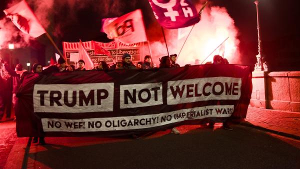 Anti-World Economic Forum (WEF) protesters march through streets of Zurich, Switzerland carrying a large banner which reads: "TRUMP NOT WELCOME: NO WEF! NO OLIGARCHY! NO IMPERIALIST WAR!"
