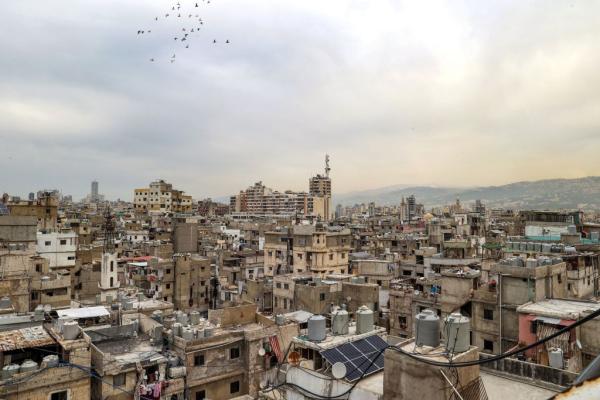 Birds fly over the rooftops of homes in the crowded Shatila Refugee Camp in Beirut, Lebanon.