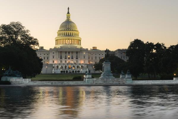 A view of the US Capitol building and its reflection over the Capitol Reflecting Pool.