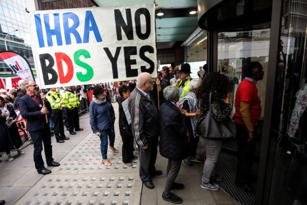 Rally outside of Labour Party vote on adopting the IHRA definition of antisemitism. Protestors carry large banner that says, "IHRA NO, BDS YES."