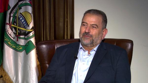 Saleh Al Arouri in a television interview, with a Hamas flag in the background.