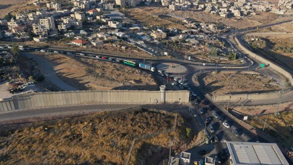Aerial view of a line of Palestinian cars in a long line at an Israeli military checkpoint in the West Bank town of Hizma.